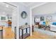Inviting entryway featuring hardwood floors, a decorative mirror, and views of the living room and kitchen at 1116 Berry Ridge Rd, Charlotte, NC 28270
