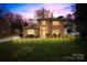 Charming two-story brick home with a well-manicured lawn and inviting walkway with pathway lighting at 1116 Berry Ridge Rd, Charlotte, NC 28270