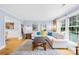 Bright and airy living room with a large sectional sofa, decorative mirrors and hardwood flooring at 1116 Berry Ridge Rd, Charlotte, NC 28270
