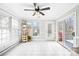 Airy sunroom featuring tile flooring, large windows, and access to the backyard deck at 1116 Berry Ridge Rd, Charlotte, NC 28270