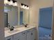 Elegant bathroom featuring a double sink vanity with white quartz countertops and modern black fixtures at 1120 Red River Rd, Salisbury, NC 28144