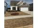 New construction home featuring stone accents, a two-car garage, and a well-maintained front yard at 1120 Red River Rd, Salisbury, NC 28144