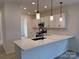 Modern kitchen boasts white cabinets, quartz countertops, stainless steel appliances, and stylish pendant lighting at 1120 Red River Rd, Salisbury, NC 28144