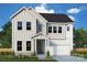 Charming two-story home featuring vertical siding, a stone foundation, and an attached two-car garage at 11208 Shreveport Dr, Huntersville, NC