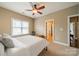 Bedroom with neutral walls and carpet, ceiling fan, and window with blinds. Adjoining bathroom entrance at 1122 Saratoga Blvd, Indian Trail, NC 28079