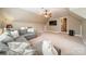 Spacious bonus room with gray couch, neutral walls and carpet, ceiling fan and a wall-mounted television at 1122 Saratoga Blvd, Indian Trail, NC 28079