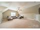 Large bonus room with gray couch, neutral walls and carpet, ceiling fan and a window at 1122 Saratoga Blvd, Indian Trail, NC 28079