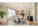 Elegant dining room featuring a stylish chandelier, wainscoting, and a large window for natural light at 1122 Saratoga Blvd, Indian Trail, NC 28079