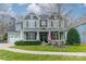 Charming two-story home with a covered front porch, lush landscaping, and a well-maintained lawn at 1122 Saratoga Blvd, Indian Trail, NC 28079