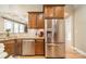 Well-lit kitchen featuring stainless steel appliances, wooden cabinets, and granite countertops at 1122 Saratoga Blvd, Indian Trail, NC 28079