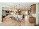 Open kitchen with stainless steel appliances and views to living and dining rooms at 1122 Saratoga Blvd, Indian Trail, NC 28079