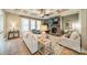 Comfortable living room with a stone fireplace, coffered ceiling, and large windows for natural light at 1122 Saratoga Blvd, Indian Trail, NC 28079