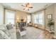 Cozy living room with abundant natural light, ceiling fan, and a charming fireplace feature at 1122 Saratoga Blvd, Indian Trail, NC 28079