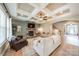Living room with coffered ceilings, stone fireplace and light colored couches at 1122 Saratoga Blvd, Indian Trail, NC 28079