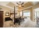 Spacious main bedroom with tray ceiling, four-poster bed, and sitting area at 1122 Saratoga Blvd, Indian Trail, NC 28079
