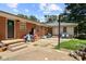 Backyard of a brick home features a patio and some outdoor furniture and recreational objects at 1210 Brookwood Dr, Shelby, NC 28150