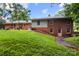 Home's exterior shows brick facade, green yard and a partially-shaded lawn at 1210 Brookwood Dr, Shelby, NC 28150