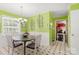 A bright dining room features green walls with white trim and vintage light fixture at 1210 Brookwood Dr, Shelby, NC 28150