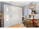 Inviting foyer featuring a decorative mirror, wooden floors, and a bright, welcoming ambiance at 1210 Brookwood Dr, Shelby, NC 28150