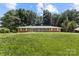 Well-maintained, single-story home with brick facade and lush greenery, showcasing serene, suburban living at 1210 Brookwood Dr, Shelby, NC 28150