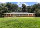 Ranch-style brick home with large front yard and mature trees offers classic charm and curb appeal at 1210 Brookwood Dr, Shelby, NC 28150