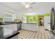 Bright, vintage kitchen featuring white cabinets, black countertops, and a unique tiled floor at 1210 Brookwood Dr, Shelby, NC 28150