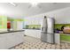 Spacious kitchen includes stainless steel refrigerator, white cabinets, and a tile floor at 1210 Brookwood Dr, Shelby, NC 28150