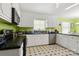 Cozy kitchen features white cabinetry, black countertops, and a stainless steel dishwasher at 1210 Brookwood Dr, Shelby, NC 28150