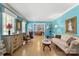 Open-concept living area with blue walls, hardwood floors, and stylish furnishings at 1210 Brookwood Dr, Shelby, NC 28150