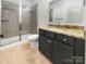 Modern bathroom features a tiled shower, granite countertop, and vanity with storage at 12326 Cranberry Glades Dr, Cornelius, NC 28031