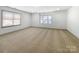 Spacious bedroom with carpet floors and large windows for natural light at 12326 Cranberry Glades Dr, Cornelius, NC 28031