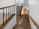 Wooden staircase features dark iron spindles and wooden handrail at 12326 Cranberry Glades Dr, Cornelius, NC 28031