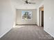 Bright, carpeted bedroom with a ceiling fan, window, and a view into an open closet space at 12616 Tucker Crossing Ln, Charlotte, NC 28273