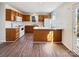 A kitchen with wood cabinets, white appliances, and wood-look flooring at 12616 Tucker Crossing Ln, Charlotte, NC 28273