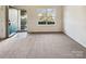 Spacious living room with large window that provides natural light and neutral carpet flooring at 12616 Tucker Crossing Ln, Charlotte, NC 28273
