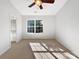 Bright bedroom with natural light, neutral carpet, ceiling fan, and en-suite bathroom access at 13510 Tranters Creek Ln, Charlotte, NC 28273