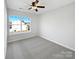 Neutral bedroom with a large window, ceiling fan, and plush carpeting at 13510 Tranters Creek Ln, Charlotte, NC 28273