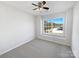 Comfortable bedroom with great natural light from the oversized window and ceiling fan at 13510 Tranters Creek Ln, Charlotte, NC 28273