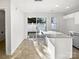Open kitchen with island and sliding glass door to the backyard, creating a light-filled space at 13510 Tranters Creek Ln, Charlotte, NC 28273
