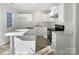Bright kitchen features white cabinets, stainless steel appliances, and a functional island at 13510 Tranters Creek Ln, Charlotte, NC 28273