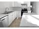 Modern kitchen features white cabinetry, stainless steel appliances, and light countertops at 13510 Tranters Creek Ln, Charlotte, NC 28273