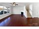 Spacious living room features hardwood floors, a fireplace and staircase at 13510 Tranters Creek Ln, Charlotte, NC 28273