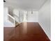 Empty living room featuring hardwood floors and staircase at 13510 Tranters Creek Ln, Charlotte, NC 28273