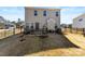 The backyard features a patio, black metal fence, and a view of other houses at 14030 Turncloak Dr, Charlotte, NC 28278