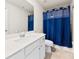 Clean bathroom featuring modern vanity with sink, a toilet, and shower with a stylish blue curtain for privacy at 14030 Turncloak Dr, Charlotte, NC 28278