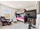 A cozy bedroom features a bunk bed, comfortable seating, a large window, and a modern exercise bike at 14030 Turncloak Dr, Charlotte, NC 28278