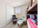 A bedroom showcasing a bunk bed, two comfy chairs with ottomans, and a bright window at 14030 Turncloak Dr, Charlotte, NC 28278