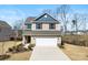 Charming two-story home features a well-manicured front yard, attached two-car garage, and inviting curb appeal at 14030 Turncloak Dr, Charlotte, NC 28278