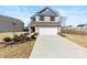 Charming two-story home with a well-manicured front yard and an attached two-car garage at 14030 Turncloak Dr, Charlotte, NC 28278