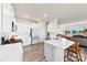 The kitchen offers white cabinets, stainless steel appliances, quartz countertops and island seating at 14030 Turncloak Dr, Charlotte, NC 28278